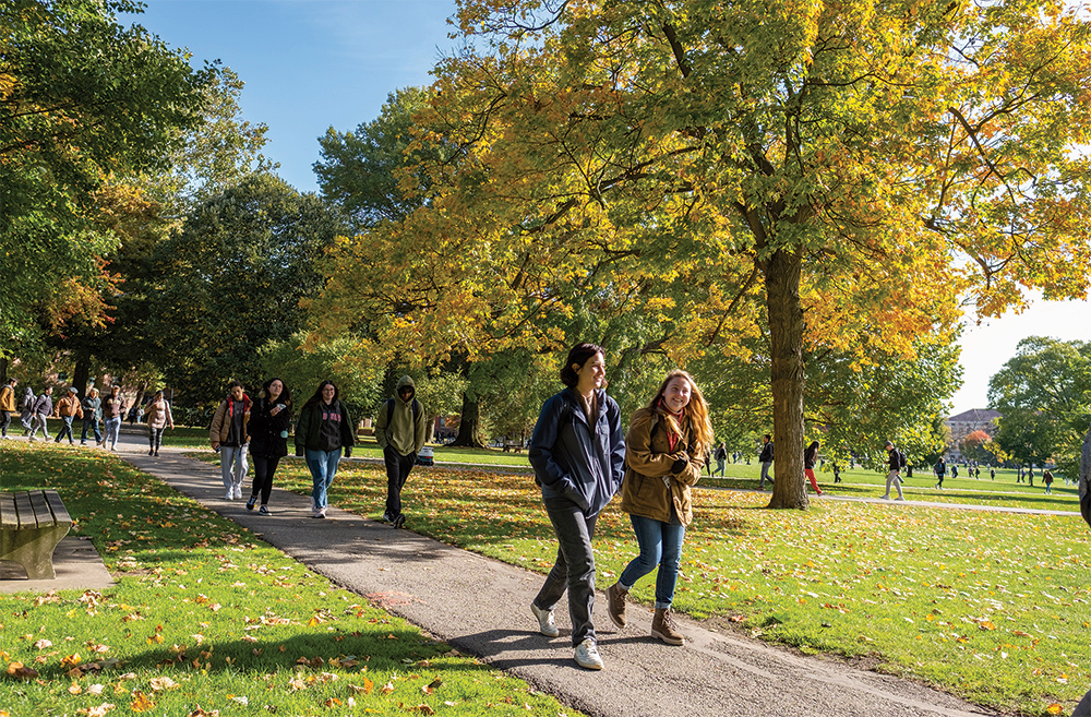 Multiple students walking on a path at the Oval