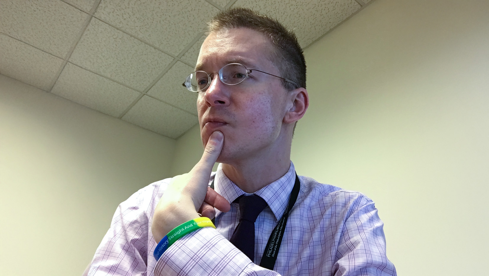 Alex Grieco portrait with thumb on chin thoughtfully